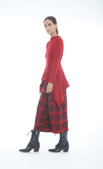 Load image into Gallery viewer, Front left side full body view of a woman wearing the mxmatthidlur lana top in red. This top has long sleeves, longer sides, and a high boat neck.
