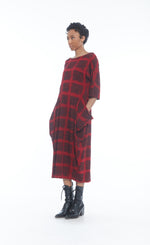 Load image into Gallery viewer, Front full body view of a woman wearing the mxmatthildur mavis dress in a red and black plaid print. This dress has 3/4 length sleeves, large pockets, and sits below the knees.
