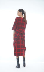 Load image into Gallery viewer, Back full body view of a woman wearing the mxmatthildur mavis dress in a red and black plaid print. This dress has 3/4 length sleeves, and large pockets that are pulled to the back and tied together.
