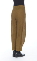 Load image into Gallery viewer, Back bottom half view of a woman wearing the mxmatthildur roxanne pant in the color mustard and black. This striped pant has a relaxed barrel leg and a minor drape at the bottom.
