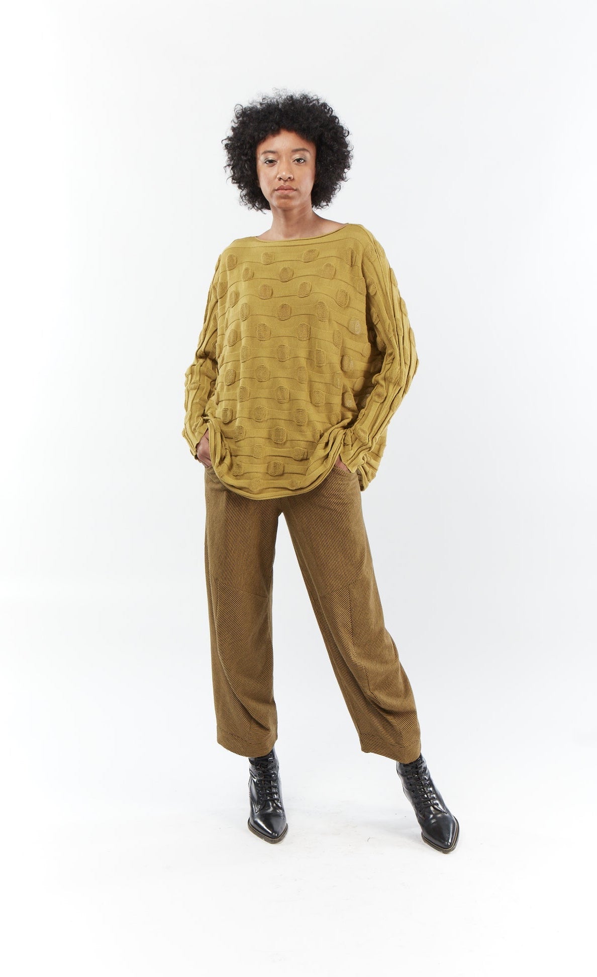 Front full body view of a woman wearing the mxmatthildur bubble sweater and the mxmatthildur roxanne pant in the color mustard and black. This striped pant has a relaxed barrel leg and a minor drape at the bottom.