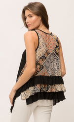 Load image into Gallery viewer, Back top half view of a woman wearing the Mystree Sleeveless Ruffle Hem Top. This tank top has a mixed floral print on the back with black and floral print ruffles on the hem. 
