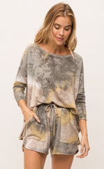 Load image into Gallery viewer, Front top half view of a woman wearing the mystree bluestone tie dye top. This top is a grey and yellow tie top with long sleeves and a boxy fit.
