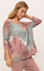 Load image into Gallery viewer, Front, right sided top half view of a woman wearing the mystree vintage tie dye top and the mystree lounge pant. The top is pink and blue tie dye and has long drop shoulder sleeves and a boxy fit. The bottoms are burgundy pink with a relaxed fit, pockets, and a white waistband.
