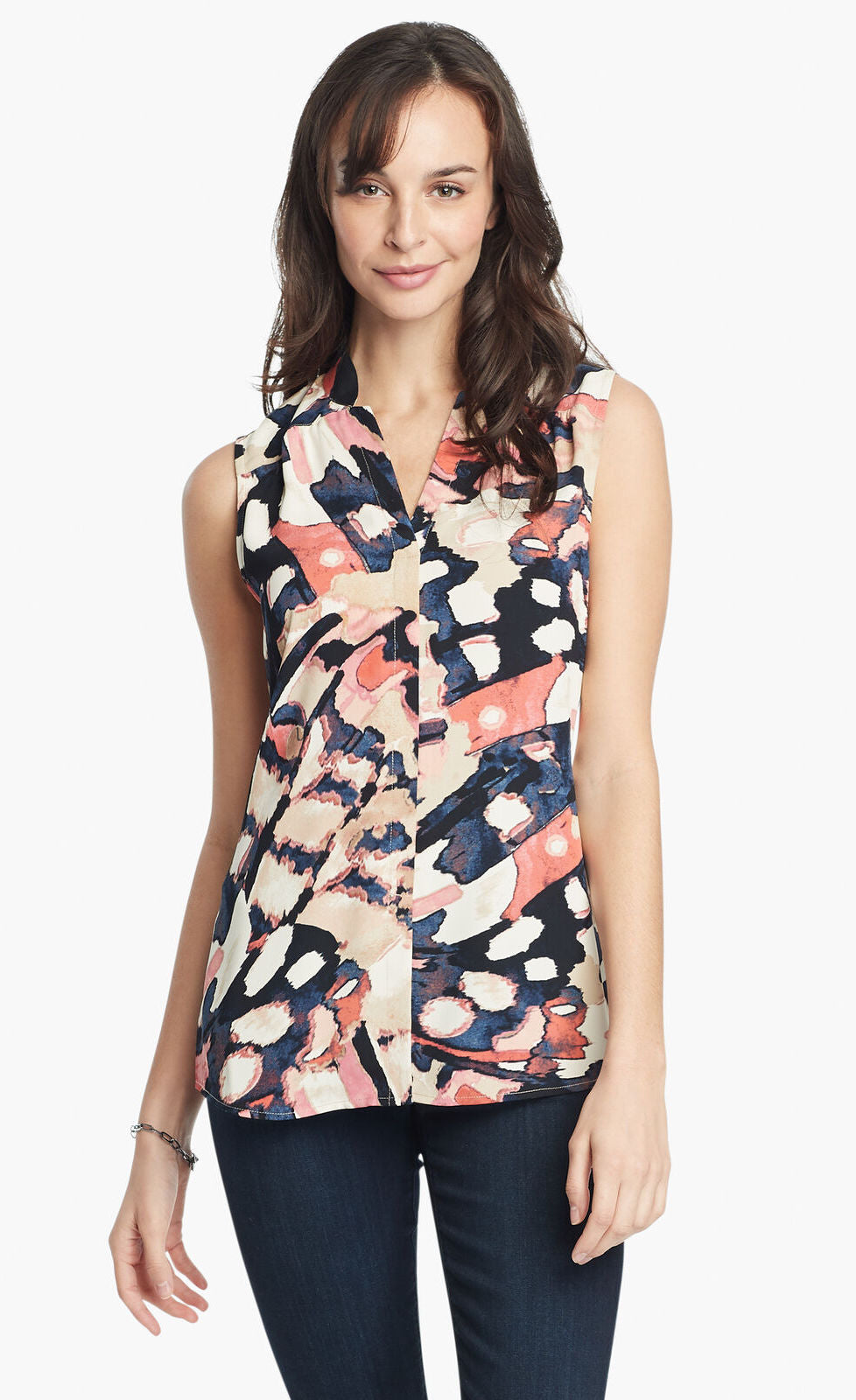 Front, top half view of a woman wearing the nic+zoe all aflutter tank. This sleeveless tank features a abstract indigo and mixed pink print and a v-neck.