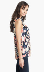 Load image into Gallery viewer, Right side, top half view of a woman wearing the nic+zoe all aflutter tank. This sleeveless tank features a abstract indigo and mixed pink print.
