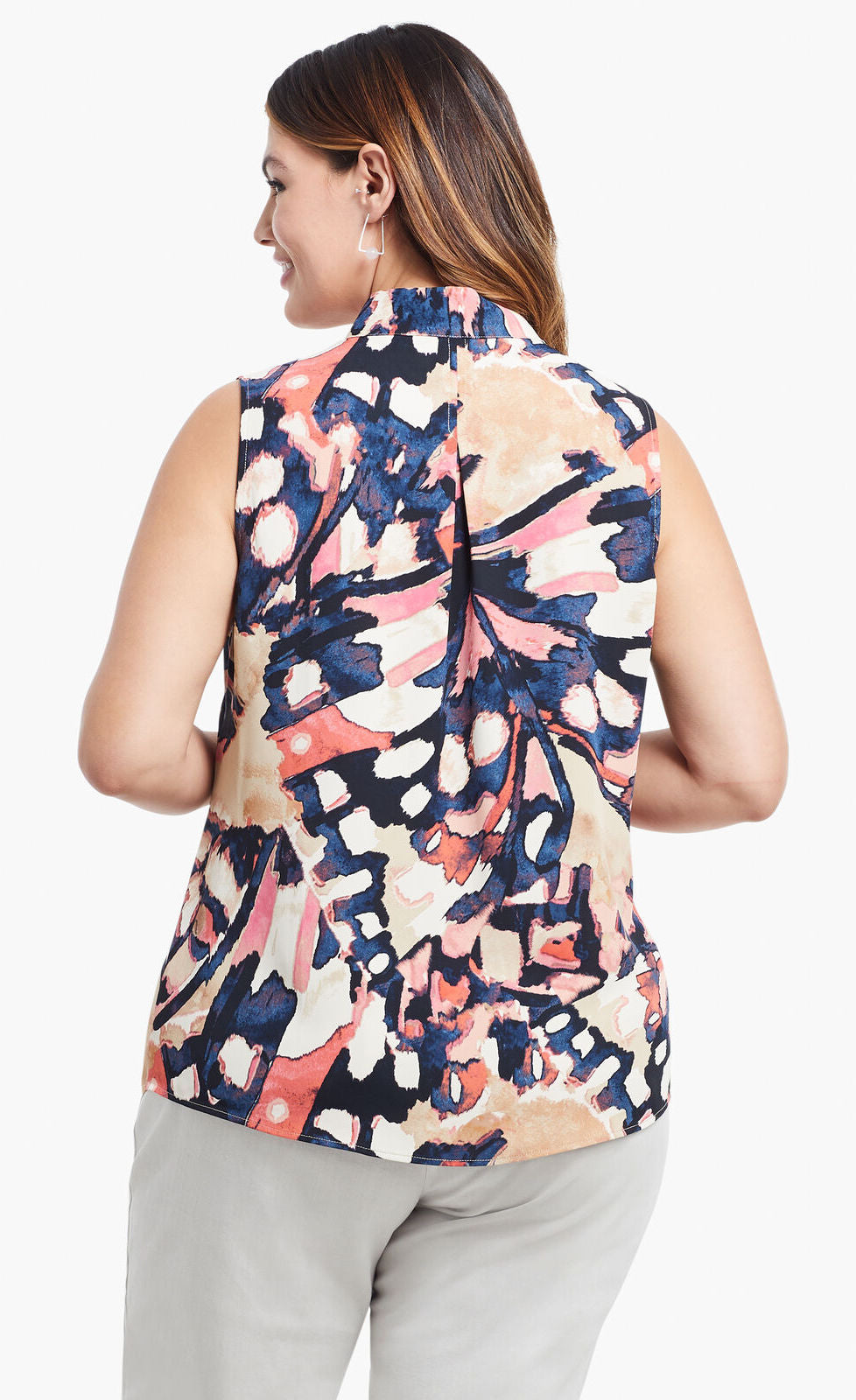 Back, top half view of a woman wearing the nic+zoe all aflutter tank. This sleeveless tank features an abstract indigo and mixed pink print and an inverted back pleat.