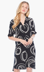 Load image into Gallery viewer, Front full body view of a woman wearing the nic+zoe billow dress. This dress is black with white swirl print all over it. The dress has a 3/4 button up front, elbow length sleeves, and front pockets.
