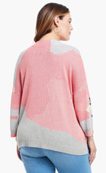 Load image into Gallery viewer, Back top half view of a model wearing the nic+zoe citrus splash sweater in a plus size. This sweater is mainly pink with abstract colors of grey, blue, and creme all over it. This sweater has long drop shoulder sleeves.
