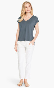 Front full body view of a woman wearing white pants and the Nic+Zoe Eaze V Tee. This tee is slate and has short sleeves and a v-neck.