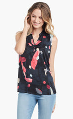 Load image into Gallery viewer, Front view of woman pushing hair behind her ear. Woman is wearing light blue jeans and the kaleidoscope tank top from Nic+Zoe. The tank is black with abstract pink and indigo print. 
