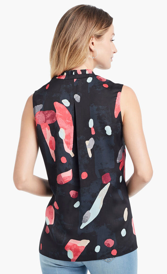 Back view of woman wearing light blue jeans and the kaleidoscope tank top from Nic+Zoe. The tank is black with abstract pink and indigo print. 
