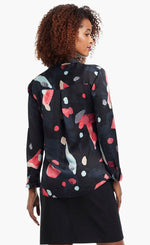 Load image into Gallery viewer, Back view of a woman wearing a black, blue &amp; pink abstract printed kaleidoscope blouse from Nic + Zoe 
