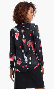 Back view of a woman wearing a black, blue & pink abstract printed kaleidoscope blouse from Nic + Zoe 