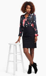 Load image into Gallery viewer, Full body front view of a woman wearing a black, blue &amp; pink abstract printed kaleidoscope blouse from Nic + Zoe tucked in to a high-waisted skirt
