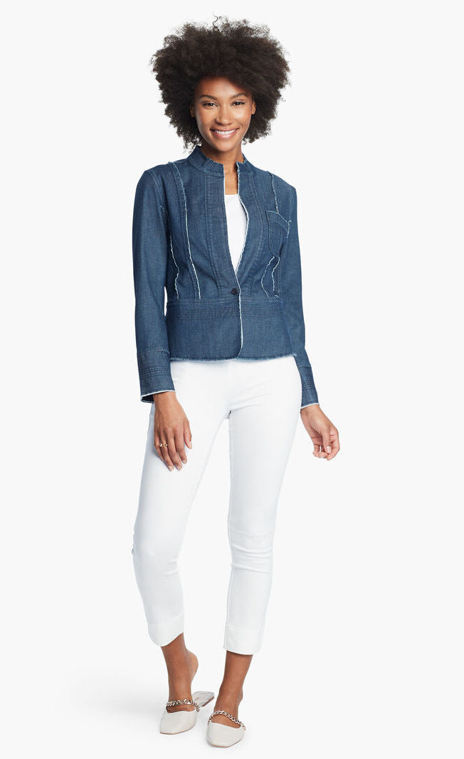 Front, full body view of a woman wearing white pants and the Nic + Zoe Favorite Denim Jacket over a white top. The dark denim jacket features frayed stitching, a single front button, and a short stand collar.