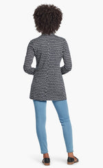 Load image into Gallery viewer, Back, full body view of a woman wearing the Nic + Zoe Ponte Ikat Jacket closed with fitted jeans. The jacket is indigo with a white speck print all over it.
