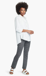Load image into Gallery viewer, Front full body view of a woman wearing a white button down shirt and the Nic + Zoe Ponte Ikat Pant. These pants are indigo with white speckled print. They have a straight leg and sit above the ankles.
