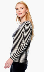 Load image into Gallery viewer, Left side top half view of a woman wearing black pants and the nic + zoe saturday stripe top. This top is black and white striped. It has long sleeves and a round neck.
