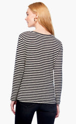 Load image into Gallery viewer, Back top half view of a woman wearing black pants and the nic + zoe saturday stripe top. This top is black and white striped. It has long sleeves and a round neck.
