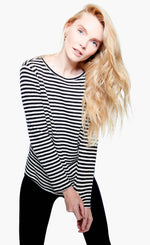 Load image into Gallery viewer, Front top half view of a woman wearing black pants and the nic + zoe saturday stripe top. This top is black and white striped. It has long sleeves and a round neck.
