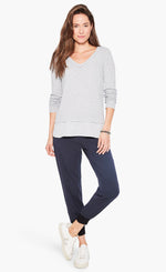 Load image into Gallery viewer, Front full body view of a woman wearing the nic and zoe stretch tencel jogger. These joggers are dark indigo with a tapered fit and side pockets.
