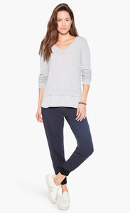 Front full body view of a woman wearing the nic and zoe stretch tencel jogger. These joggers are dark indigo with a tapered fit and side pockets.