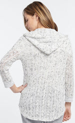 Load image into Gallery viewer, Back top half view of a woman wearing the Nic + Zoe Sweetling Zip Hoodie. The hoodie has a loose white sweater knit fabric with grey mixed into it. 
