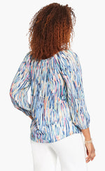 Load image into Gallery viewer, Back top half view of a woman wearing the nic+zoe toucan shirt. This top features a blue watercolor brush stroke print and 3/4 length sleeves.
