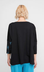 Load image into Gallery viewer, Back view of a woman wearing the ozai n ku storm top
