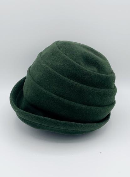 Left side view of the lillie & cohoe beatrice hat. This hat is green with a tiered/folded crown and a rounded brim.