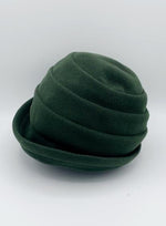 Load image into Gallery viewer, Left side view of the lillie &amp; cohoe beatrice hat. This hat is green with a tiered/folded crown and a rounded brim.
