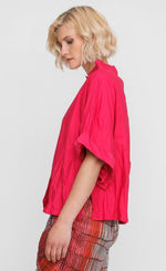 Load image into Gallery viewer, left side view of a woman wearing the ozai n ku crinkle funnel shirt in fuchsia

