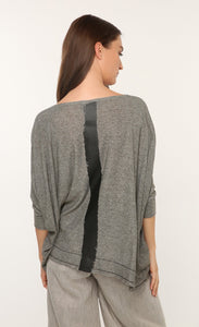 Back top half view of a woman wearing the ozai n ku marjoram top. This top is dark grey with a black painted line down the middle of the back. The top has 3/4 length sleeves.