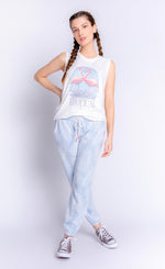 Load image into Gallery viewer, Front full body view of a woman wearing the pj salvage tropical vibes banded pant and the pj salvage tropical vibes tank. The tank is white with two flamingos printed on the front and the words &quot;tropical vibes&quot; underneath. The bottoms are sky blue with a white palm leaf print all over it.
