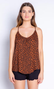 Front view of the top half of a woman wearing the PJ Salvage Wild Love Cami. This cami is mocha/brown colored with a black heart shaped animal print all over it. The round neck has two front buttons at the center.