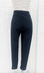 Back view of the porto fan club pant. This black pant is a jogger with large side pockets and a wide waistband