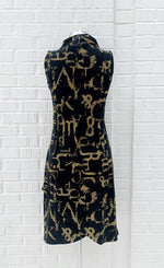 Load image into Gallery viewer, Back view of the porto popstar dress. This sleeveless dress is black with dijon newspaper letter print. The dress has a fitted silhouette with a draped mock neck.
