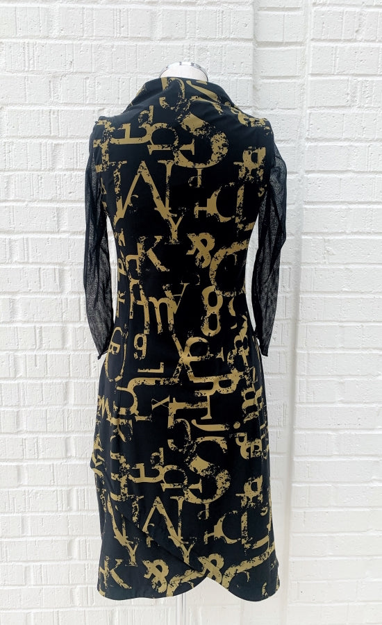 Back view of the porto popstar dress. This sleeveless dress is black with dijon newspaper letter print. The dress has a fitted silhouette with a draped mock neck.