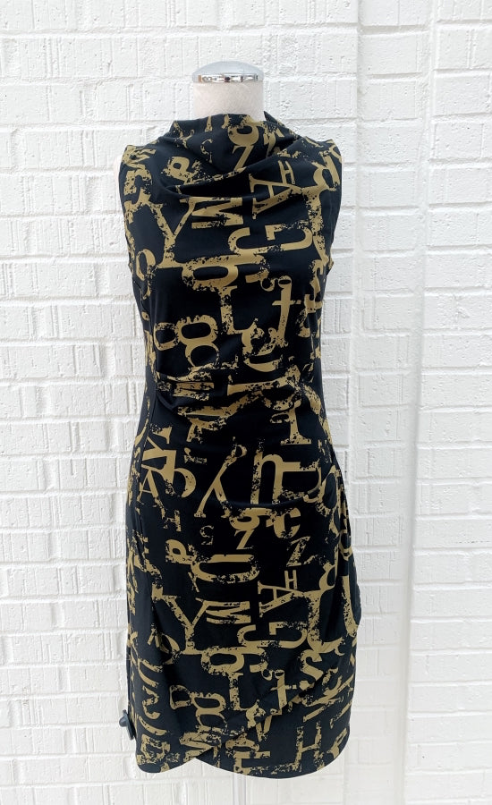 Front view of the porto popstar dress. This sleeveless dress is black with dijon newspaper letter print. The dress has a fitted silhouette with a draped mock neck.