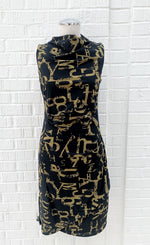 Load image into Gallery viewer, Front view of the porto popstar dress. This sleeveless dress is black with dijon newspaper letter print. The dress has a fitted silhouette with a draped mock neck.

