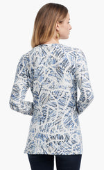 Load image into Gallery viewer, Back view of a woman wearing the Nic+Zoe Scribbled Up Top. This top has a blue abstract scribble print, long sleeves, and a boat neck.
