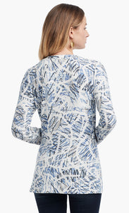 Back view of a woman wearing the Nic+Zoe Scribbled Up Top. This top has a blue abstract scribble print, long sleeves, and a boat neck.