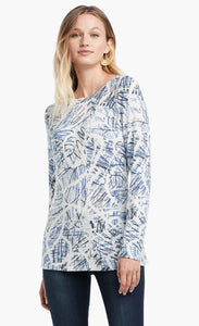 Front view of a woman wearing the Nic+Zoe Scribbled Up Top. This top has a blue abstract scribble print, long sleeves, and a boat neck.