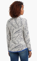 Load image into Gallery viewer, Back view of a woman wearing the Nic+Zoe New Leaf Jacket. The zip up jacket has a black and white leaf pattern and blue trim.

