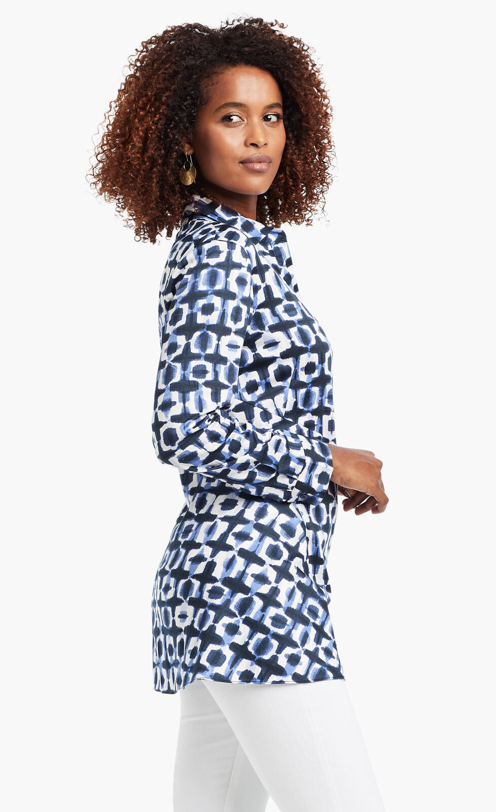 Side view of a woman wearing the Nic+Zoe Stretch Shibori Blouse. This indigo shibori printed shirt has a button down front, 3/4 length cuffed sleeves, and a collar.