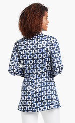 Load image into Gallery viewer, Back view of a woman wearing the Nic+Zoe Stretch Shibori Blouse. This indigo shibori printed shirt has 3/4 length cuffed sleeves, a straight silhouette, and a cut that sits below the hips.
