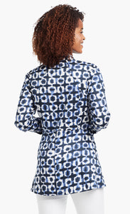 Back view of a woman wearing the Nic+Zoe Stretch Shibori Blouse. This indigo shibori printed shirt has 3/4 length cuffed sleeves, a straight silhouette, and a cut that sits below the hips.
