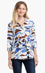 Load image into Gallery viewer, Front view of a woman wearing the Nic+Zoe In A Row Blouse. This blouse has a multi shaded blue and brown shibori print, 3/4 length sleeves, a button down front, and a front tie at the waist
