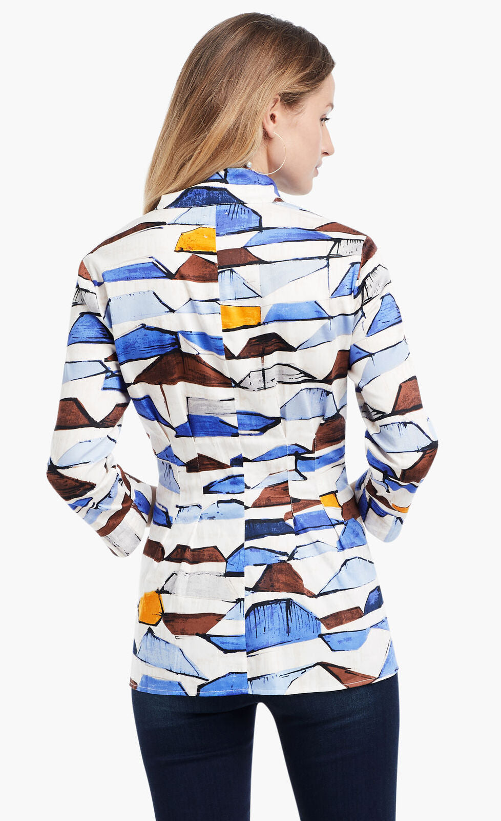 Back view of a woman wearing the Nic+Zoe In A Row Blouse. This blouse has a multi shaded blue and brown shibori print, 3/4 length sleeves, a button down front, and a cut that sits below the hips.